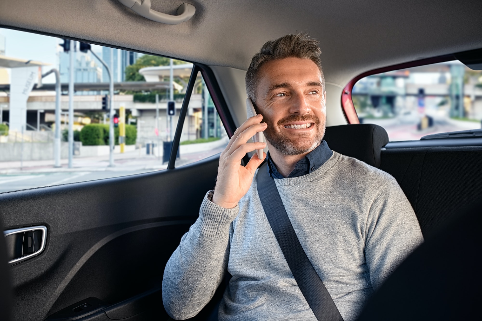 happy-mature-man-in-taxi-talking-on-phone.jpg